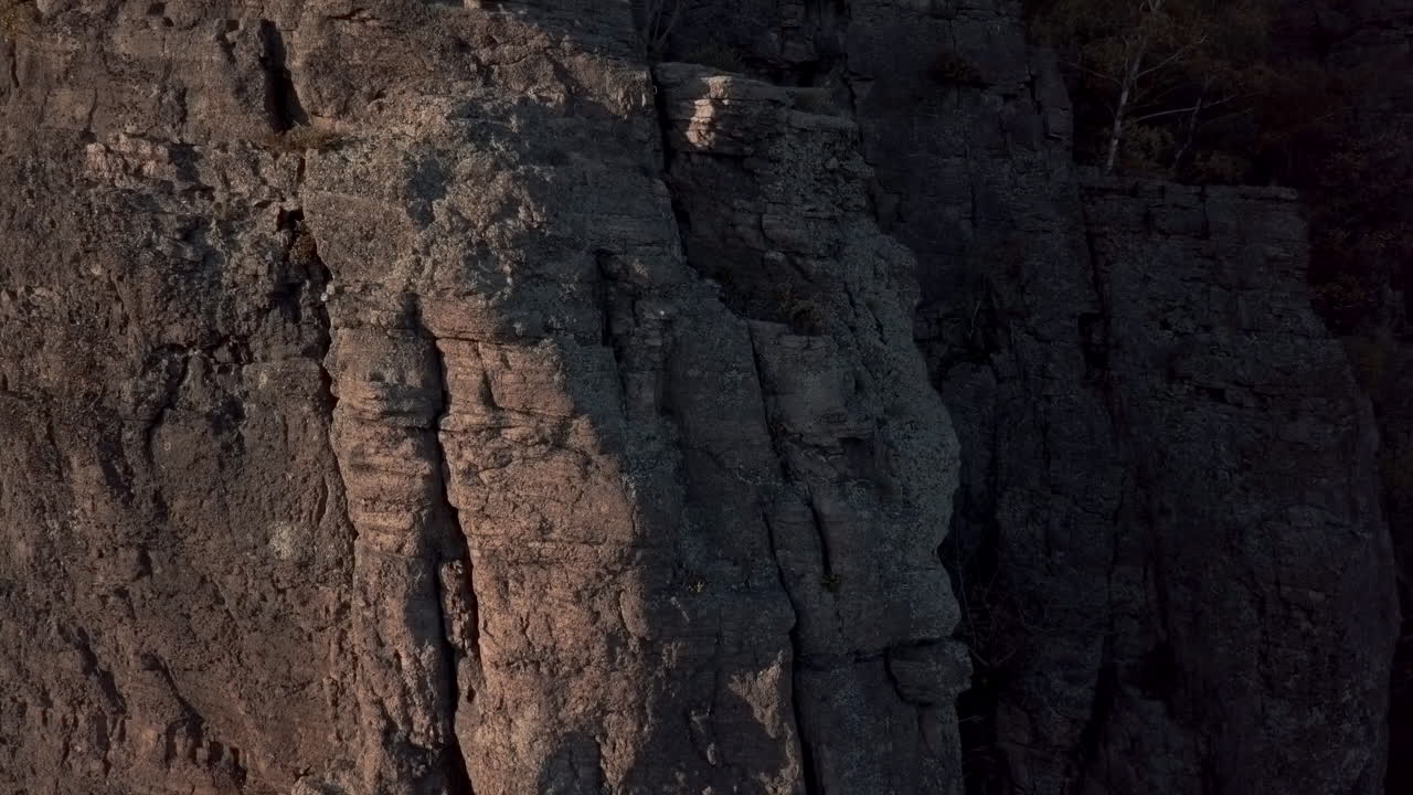 Vertical close-up shot of the rock formation Battert above the spa town of Baden-Baden revealing the setting sun in autum at golden hour revealing the valley