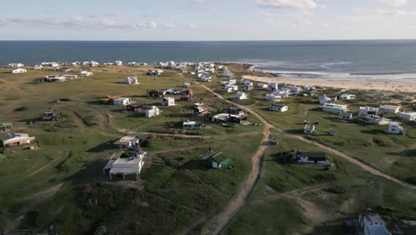Cabo-Polonio-aerial-view-of-Uruguay-holiday-destination-in-the-Rocha-Department,-little-house-over-the-sand-beach-with-ocean-view-seascape