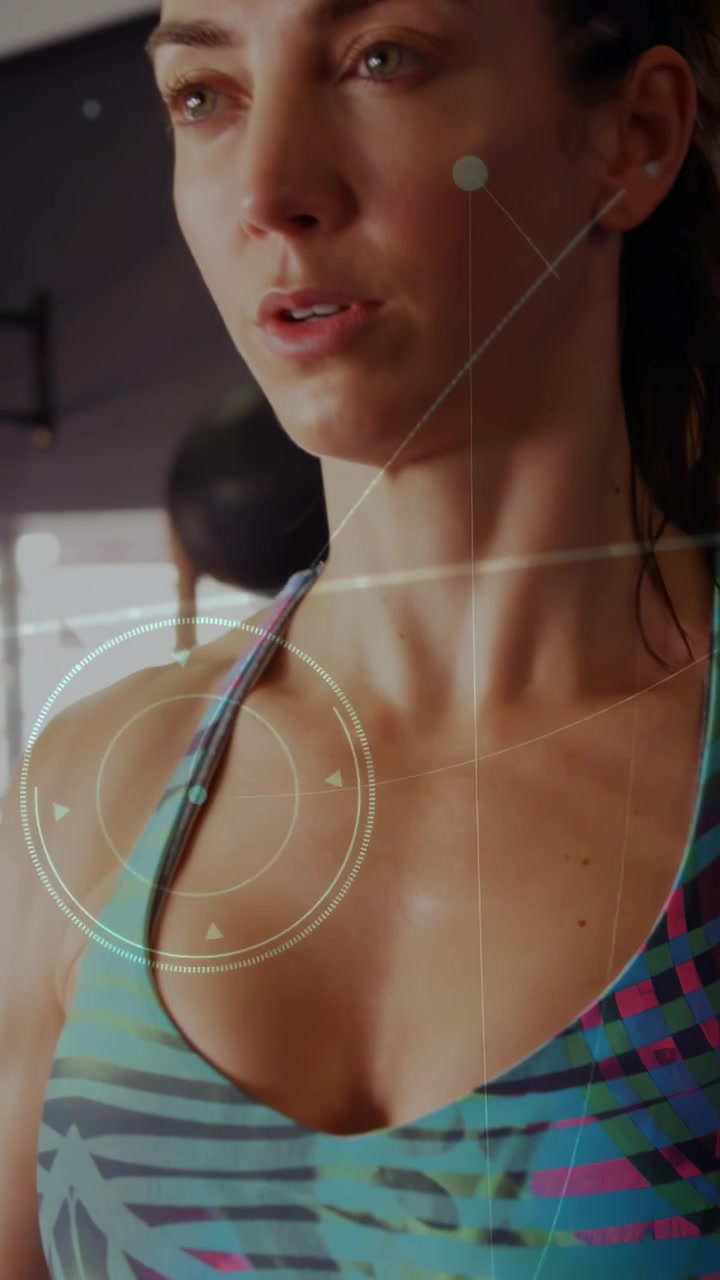 Vertical video: Woman gripping barbell, hand assisting, camera rising, keeping form, finishing lift