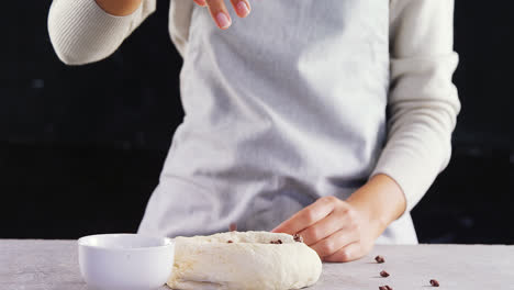 woman adding chocolate chips into the dough 4k