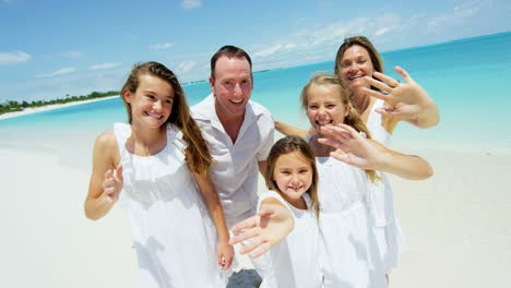 portrait of happy caucasian family on caribbean beach