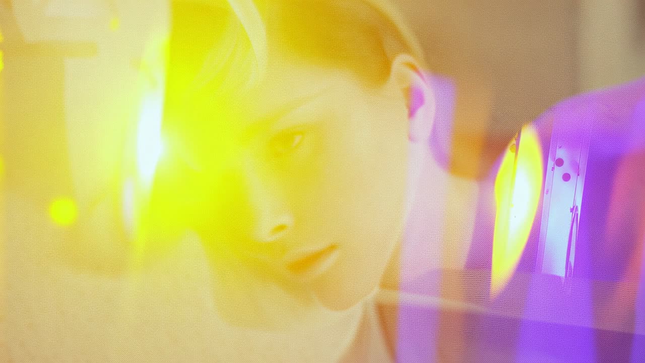 Resting woman receiving drifting colored light flares for creating calm artistic portrait in studio