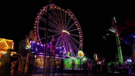 colorful ferris wheel and rides at a night carnival