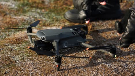 persona con guantes a la mano prepara y despliega las hélices del dron antes del vuelo