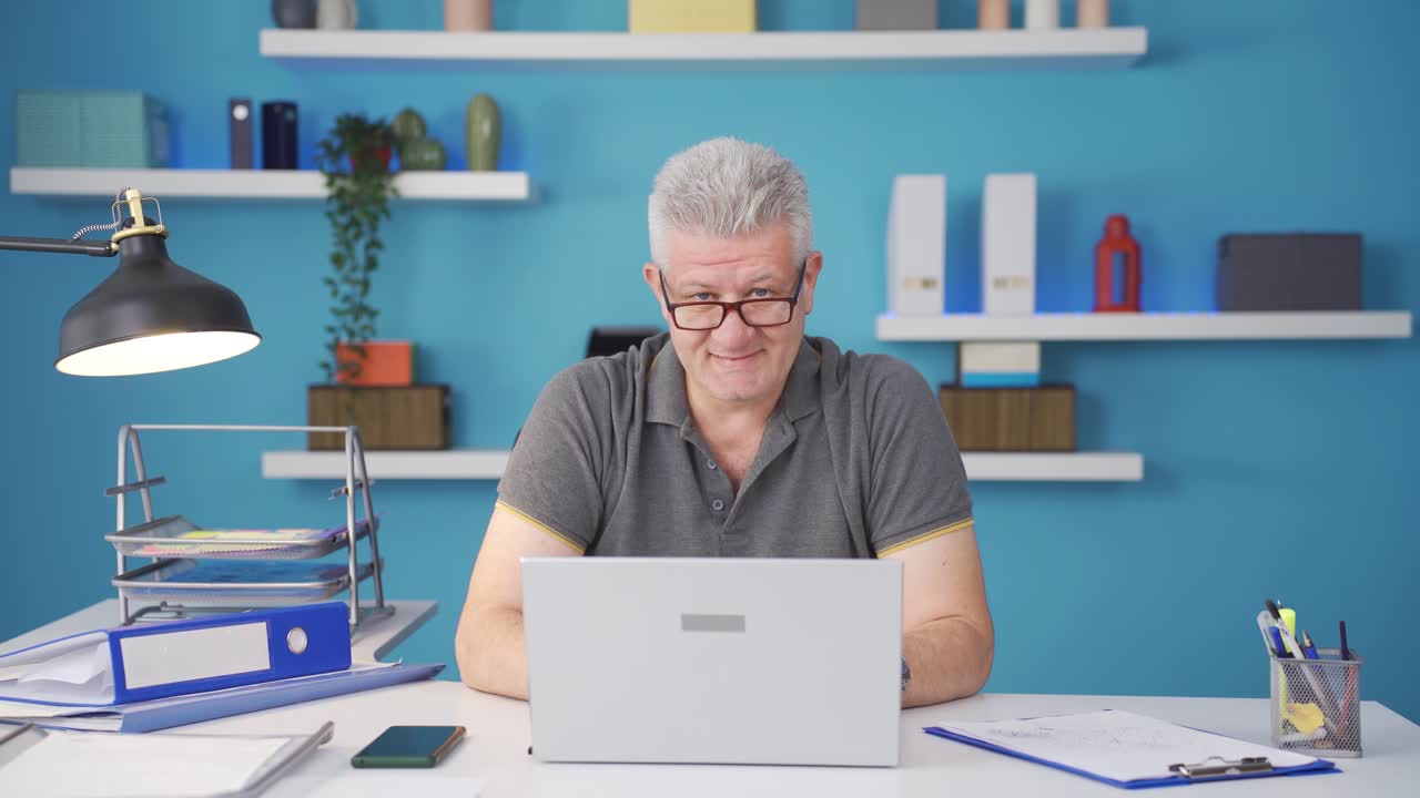 Home office worker man smiling at camera.