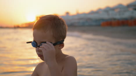 Niño-Con-Gafas-Se-Va-A-Bañar-Al-Atardecer