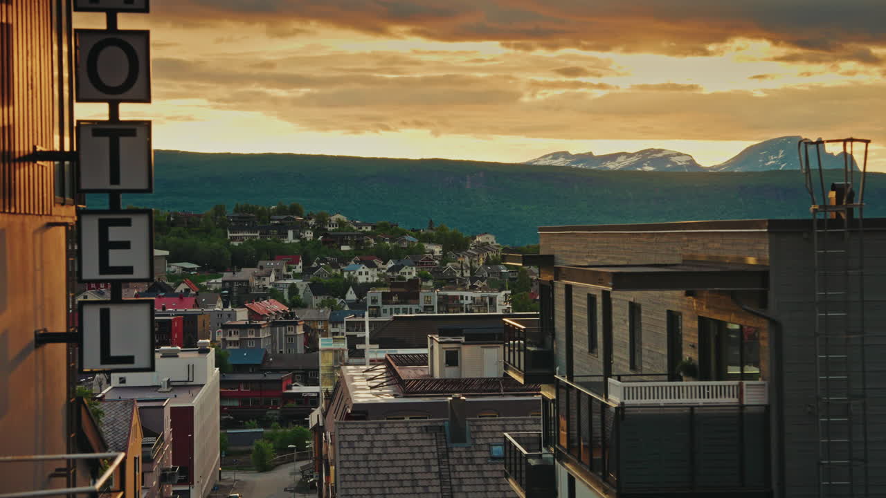 Midnight sunset over the nordic city of Narvik in Norway. View of the majestic fjords and the cloudy, golden sky.
Picturesque arctic landscape.