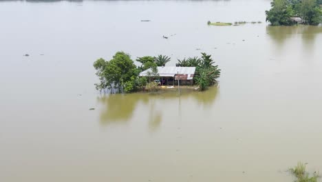 entire village with small houses submerged in flood water in bangladesh. aerial top shot