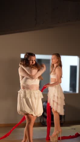 modern dance performance with red ribbon