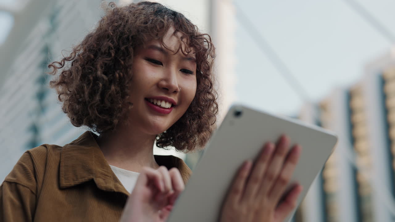 Woman using tablet in city