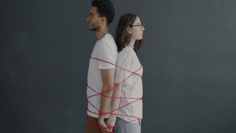 Couple Tied With Red Ribbons