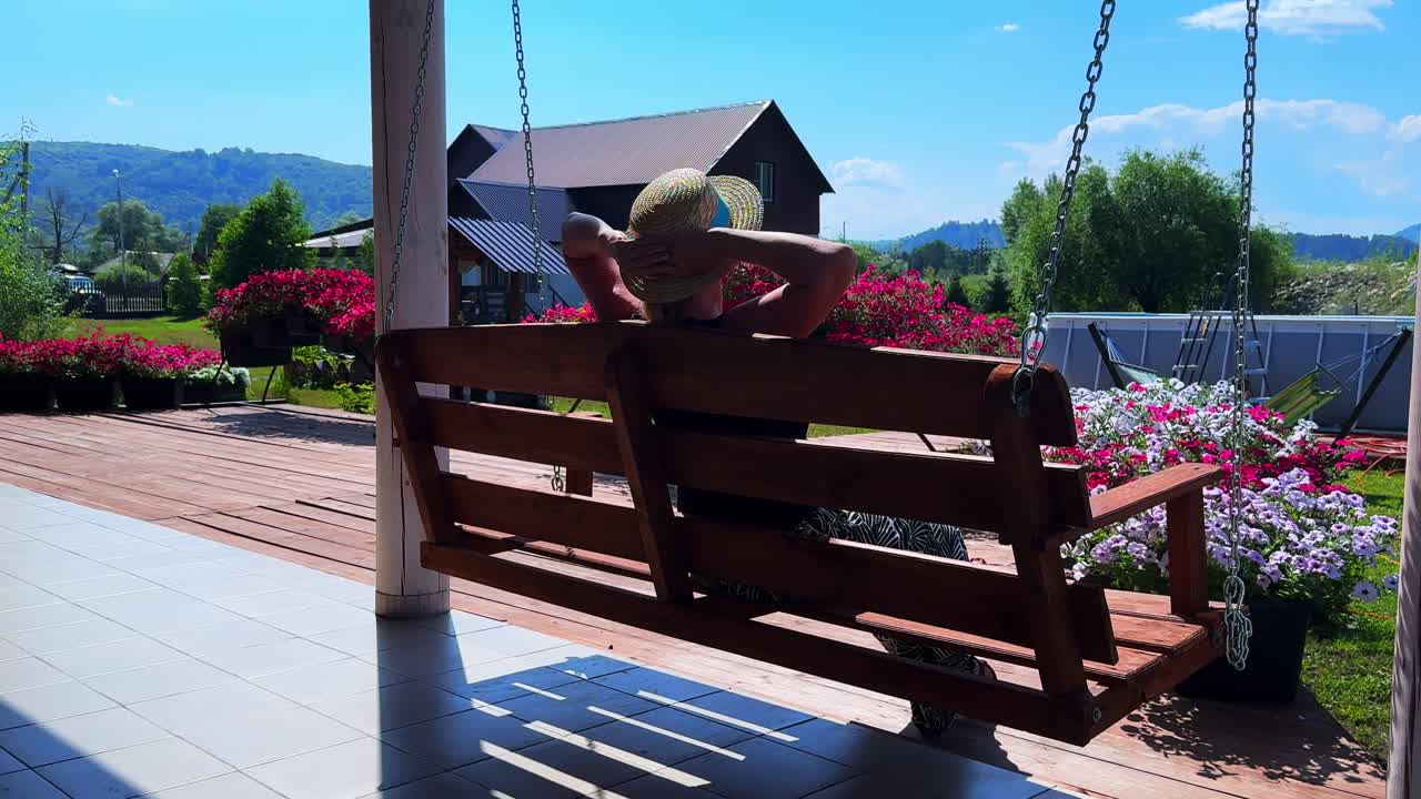 Relaxing Moments on a Swing: Enjoying Nature and Tranquility in a Beautiful Outdoor Setting Surrounded by Vibrant Flowers and Blue Skies