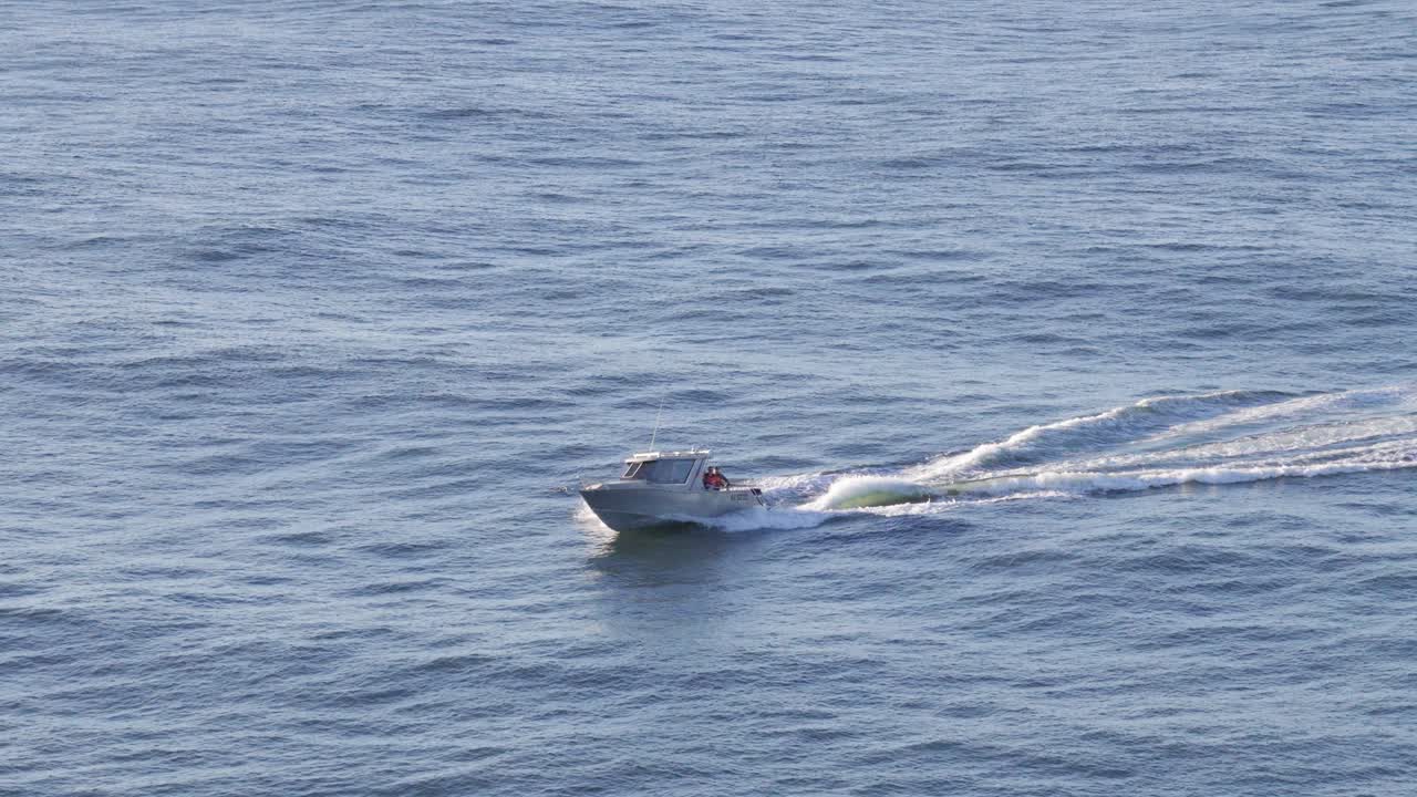 Aerial footage of a boat cruising through calm ocean waters near Gold Coast, Australia, captured in clear daylight