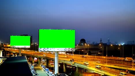 green screen of advertising billboard on expressway during the twilight with city background in bangkok, thailand.