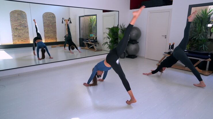 Flexible women doing yoga in studio