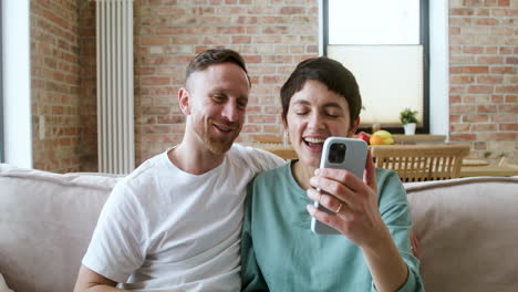 Couple-doing-videocall-on-the-sofa