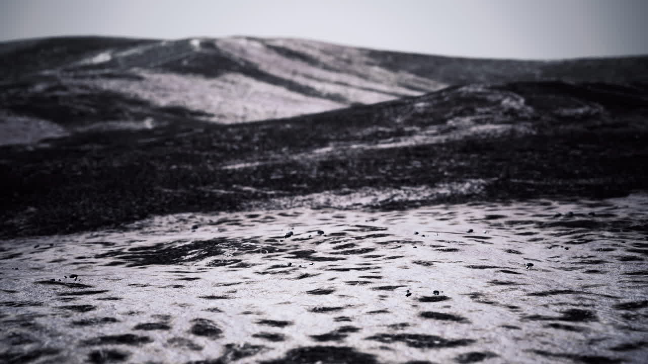 Lava landscape captures stark beauty of volcanic terrain beneath cloudy sky