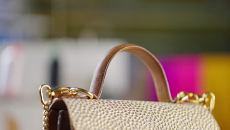 close-up of a gold handbag