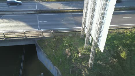 descending drone shot of a bridge over thetford river showing the high water level and the traffic situation in the outskirts of thetford in breckland district, norfolk, in united kingdom