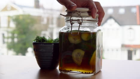 closing a jar of pickles front