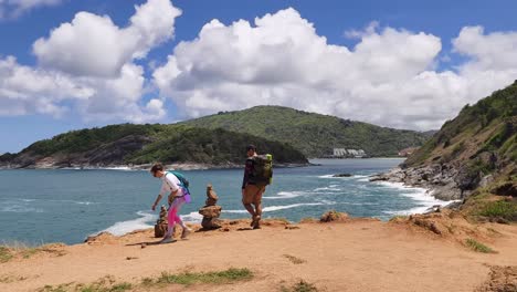 couple hiking at the beach in thailand