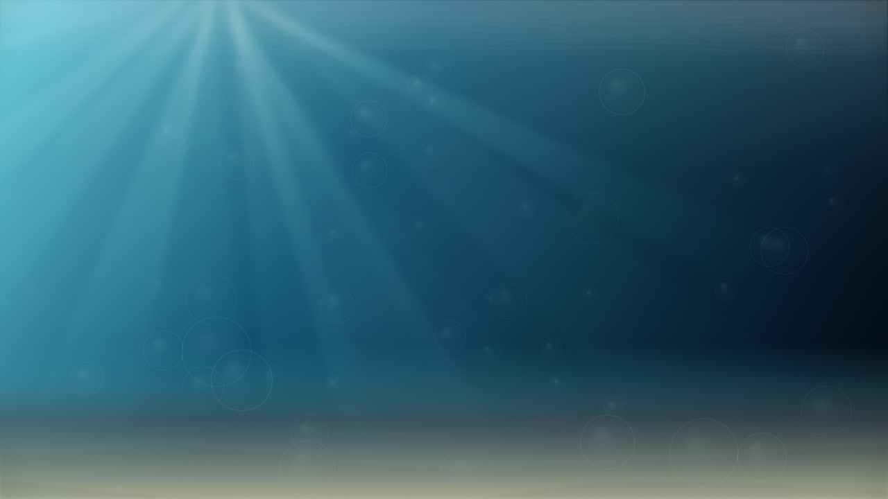 Sunlight rays penetrate deep blue water over a sandy seabed with subtle floating particles