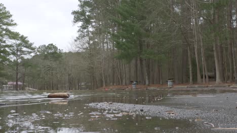 flooded-parking-lot-asphalt-water-rushing-slow-motion