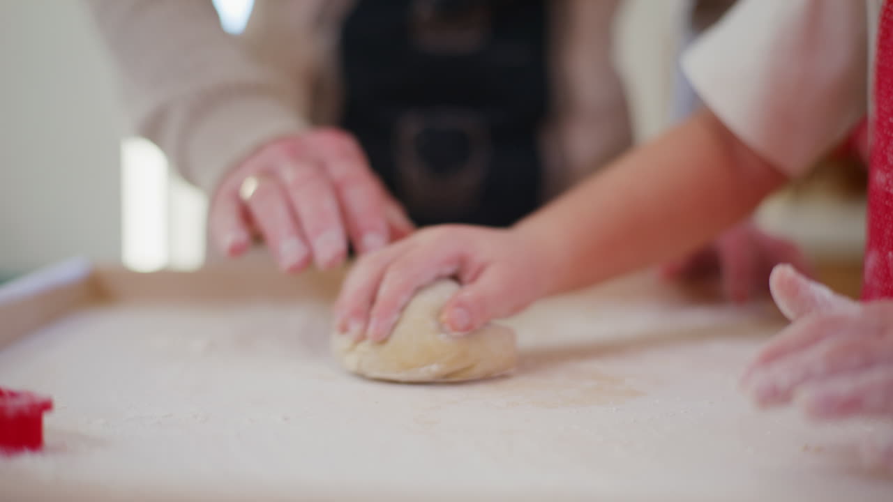Daddy Teaches Boy How To Knead And Shape Bread Dough In The Kitchen