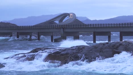 dramatic waves crashing against the atlantic ocean road bridge in norway