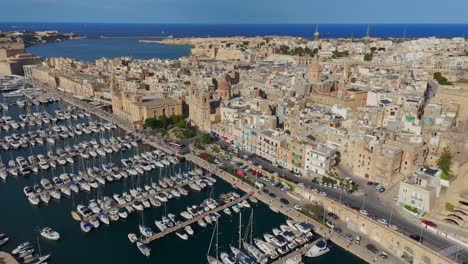 soaring above birgu, this footage captures the charm of its waterfront, bustling with yachts and fishing boats.