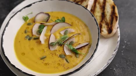 pumpkin soup with coconut flakes and toasts