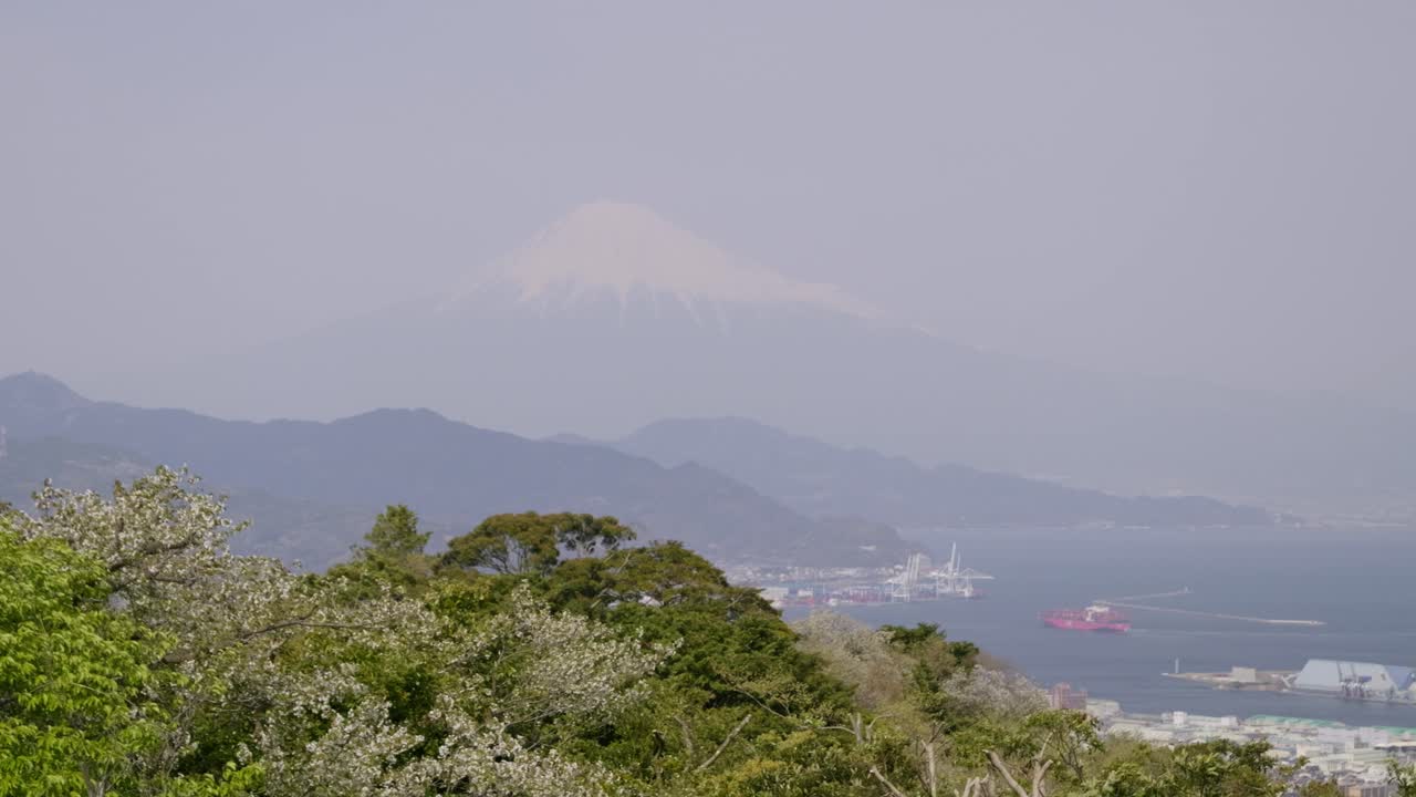 Stunning high above panorama view over Mt. Fuji next to harbor city in spring