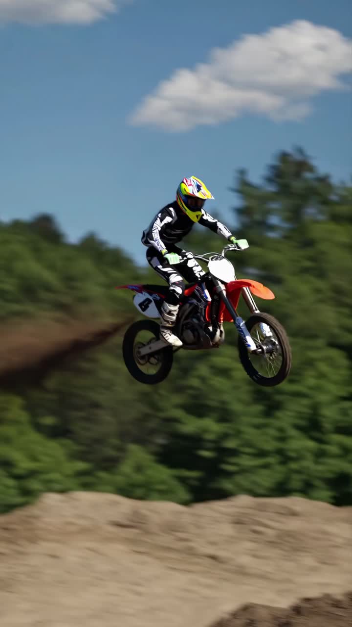Dynamic low-angle shot of a motocross rider speeding on dirt, capturing motion blur