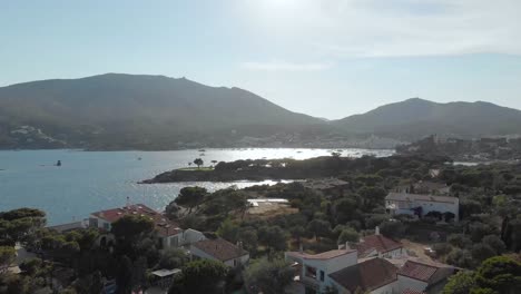 Seaside-with-mountains-and-buildings-in-sunny-day