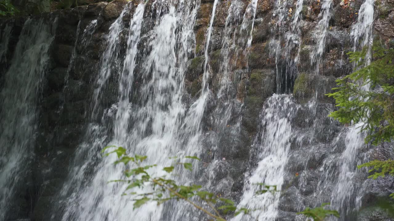 Hiking trail through lush forest leading to Sutovsky waterfall in Mala Fatra, Slovakia. Aerial view of small waterfall along the path. Scenic nature, perfect for travel and outdoor adventure themes