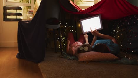 caucasian mother and daughter having fun using digital tablet