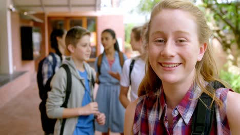 happy schoolgirl standing in school premises 4k