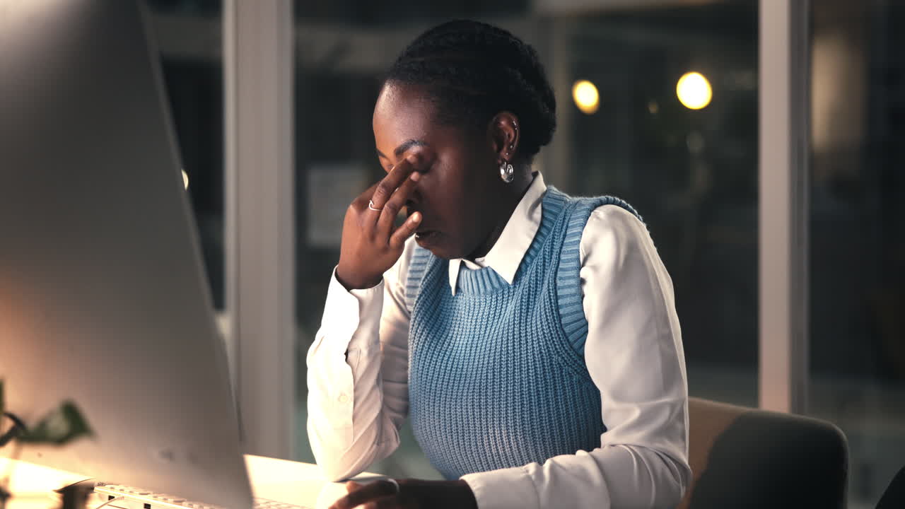 Stressed Businesswoman Rubs Tired Eyes Working Overtime on Computer