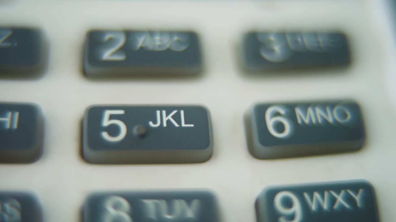 A macro close up shot of a pin pad numbers and letters on colorful buttons, zoom in movement, Full HD video, super slow motion, blurry depth of field