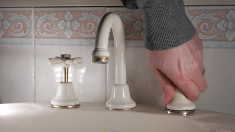 handyman replaces sleeve of a household bathroom tap