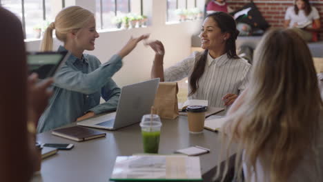 happy diverse business women meeting colleagues high five celebrating success enjoying successful project presentation in modern office workplace