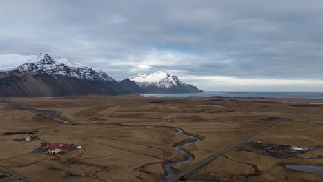 a vast icelandic landscape near hofn, featuring snowy mountains and open fields, aerial view