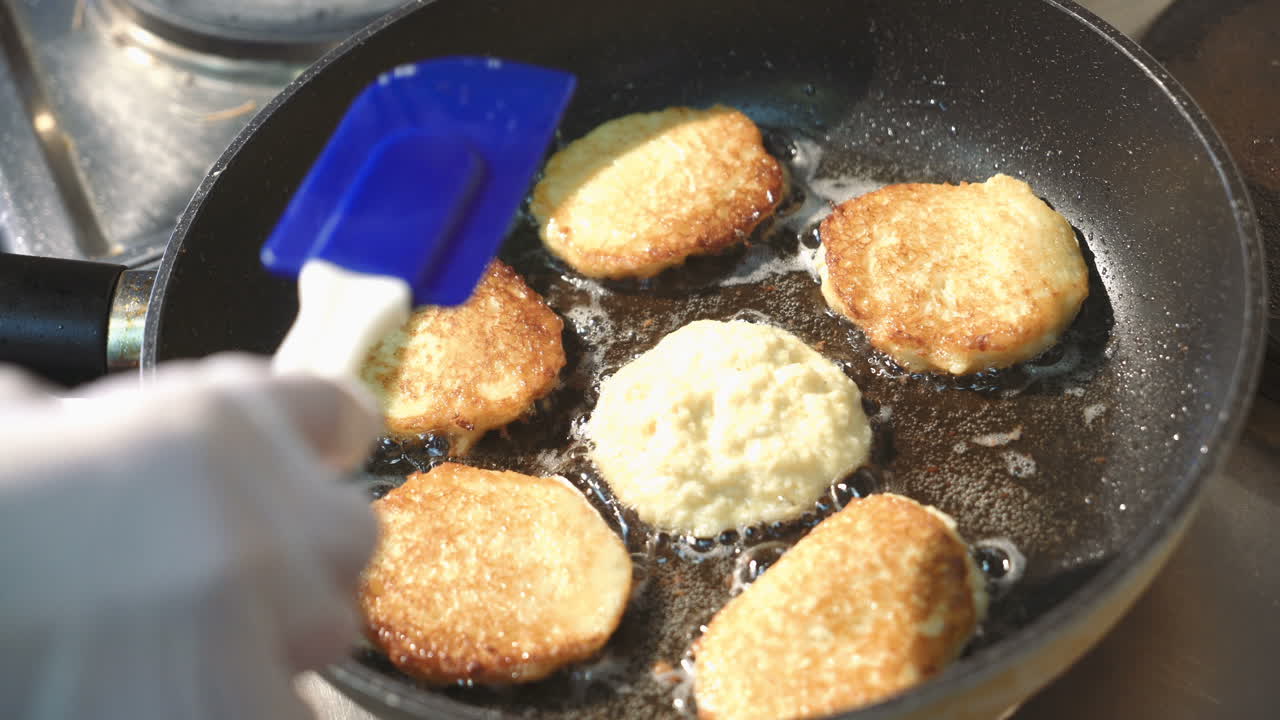 Preparation of golden crispy potato pancakes in a frying pan. Vegetable fritters.