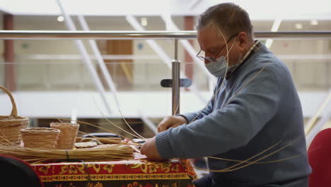 man weaving baskets