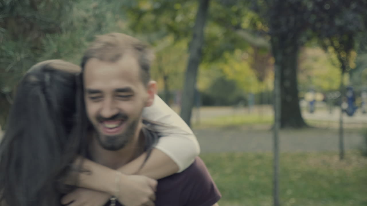 Couple enjoying a piggyback ride in the park