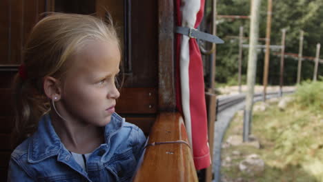 girl looking out of a vintage train window