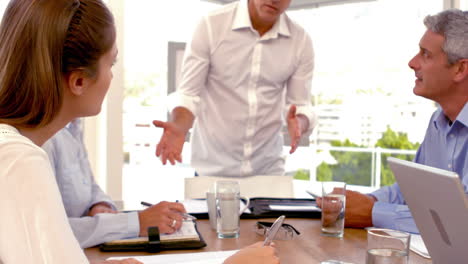 Casual-Businessman-giving-a-presentation-during-a-meeting