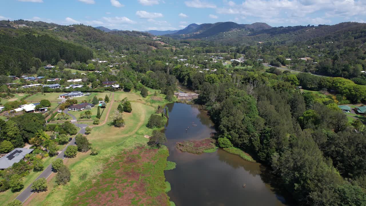 arroyo currumbin con aguas tranquilas entre la localidad y el bosque - valle de currumbin, gold coast, australia