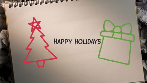 animation of hand drawing happy holidays and christmas decorations on white paper background