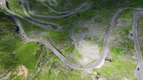 Hermosa-Vista-De-Drones-De-La-Famosa-Carretera-De-Montaña-Transfagarasan-Que-Cruza-Las-Montañas-De-Los-Cárpatos-En-Rumania,-Vista-Aérea-De-Una-Hermosa-Cordillera-Con-Picos-Altos,-Nubes-Espesas-Y-Esponjosas